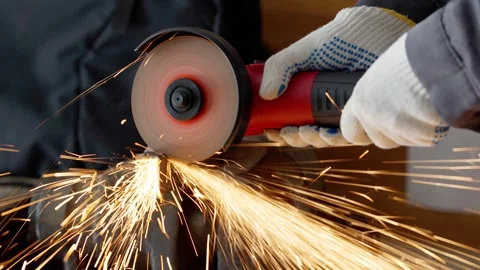 Close-up of a worker in gloves cutting metal with an angle grinder tool Stock Footage 336902759