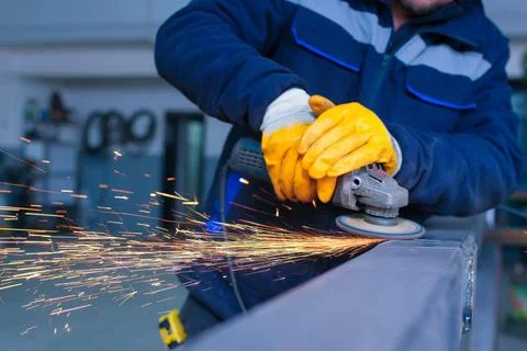 Close-up of a Worker Grinding a Metal Weld Seam with Sparks Flying Stock Photos