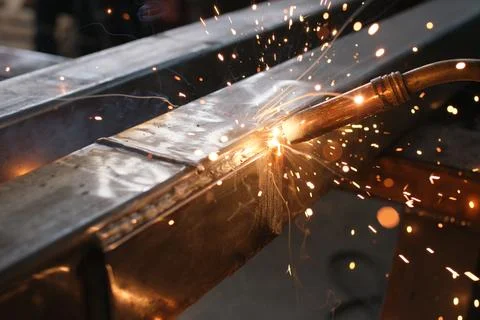 Close-up of a Worker Grinding a Metal Weld Seam with Sparks Flying Stock Photos