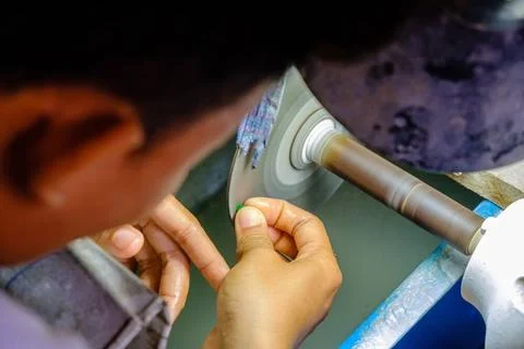 Close up of a worker grinding precious jade stones in the jade market Mand... Stock Photos