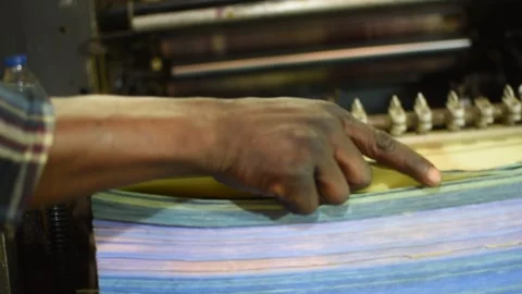 Close-up of worker hand arranging paper sheets in printing press 動画素材 326973014