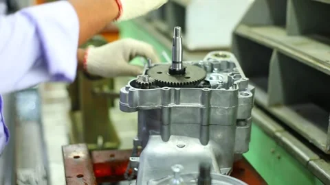 Close Up Of Worker Hands Assembling Engine Gearbox In Manufacturing Plant Vídeo Stock 345089137