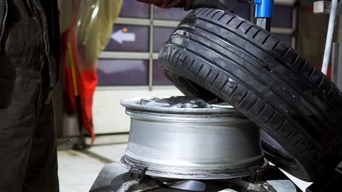 Close up of worker hands changing tire at the car service. Footage. 動画素材 127725790