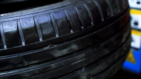 Close up of worker hands changing tire at the car service. Footage. Stock-Footage 128123601