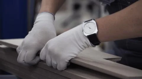 Close up worker hands with gloves squeezes elements out of cardboard mold Foto stock