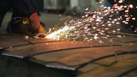 Close up of worker hands use angle grinderon metal construction metal. Sparks Stock Footage 73200570