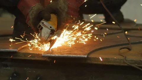 Close up of worker hands use angle grinderon metal construction metal. Sparks Stock Footage