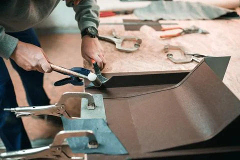 Close up of a Worker hands use scissors to cut the metal sheet Stock Photos