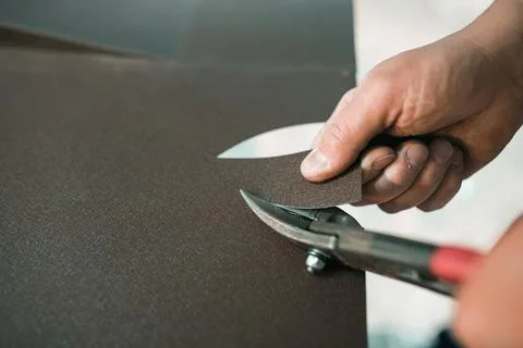 Close up of a Worker hands use scissors to cut the metal sheet Stock Photos
