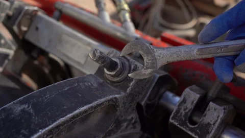 Close-Up of Worker Hands Using Wrench to Tighten Nut on Industrial Machinery Vídeos de archivo 334939146