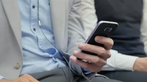 Close-up of worker holding a cell phone during his daily commute Stock Footage 67259415
