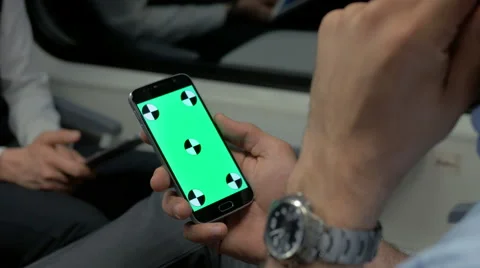 Close-up of worker holding a smartphone with green screen 스톡 동영상 67260978