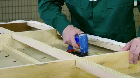 Close up of worker makes a sofa, couch or settee in a furniture factory. 4K Stock-Footage 146230290