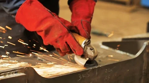 Close up of worker in mask use angle grinderon metal construction metal. Sparks Stock Footage 72757364