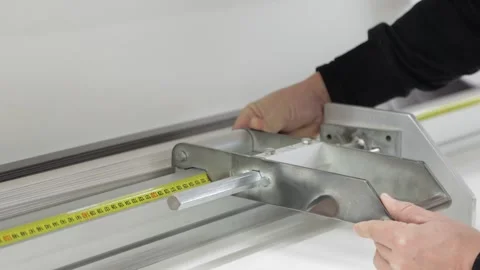 Close-up of a worker measuring and adjusting a machine Stock Footage 302473390