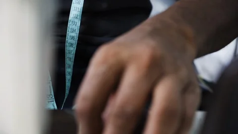 Close up of worker measuring leather in indoor factory, Kalkata, India Stock Footage 145036976