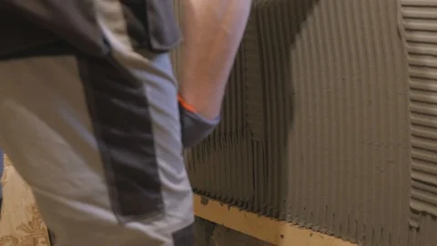 Close-up worker plastering the wall slow motion - plastering trowel Stock Footage 87405309