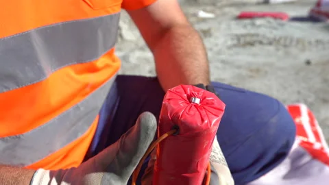 Close up of a worker preparing explosives for mining Stock Footage 232582604