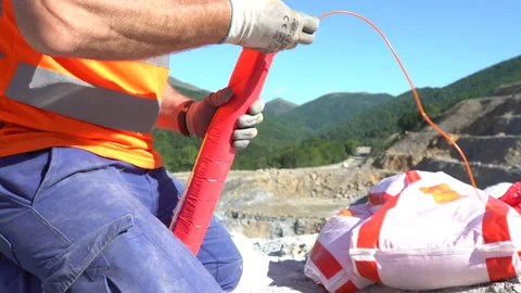 Close up of a worker preparing explosives for mining Stock Footage 232583169