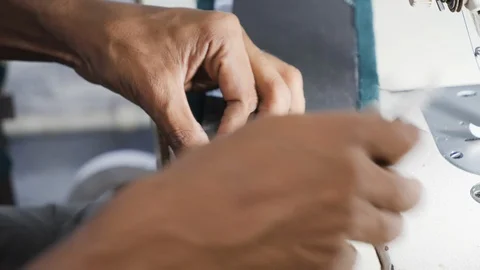 Close up of worker pressing leather in indoor factory in, Kalkata, India Stock Footage 145040806