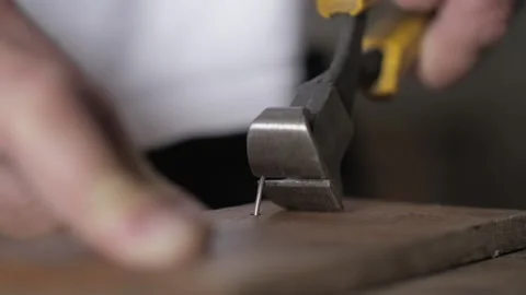 Close-up. a worker pulls a nail out of a piece of wood using pliers. workshop Stock Footage 155860949
