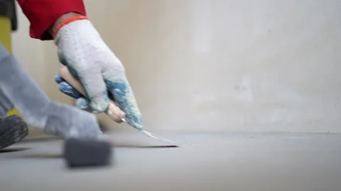 Close up of worker removes dust with a vacuum cleaner. A worker with an Stock Footage 162657936