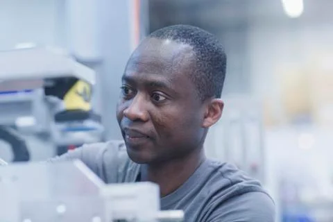 Close-up of worker repairing machine at engineering plant Stock Photos