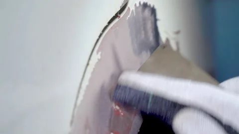 Close-up worker sanding with sandpaper old paint on the body of the car Stock Footage 132828766
