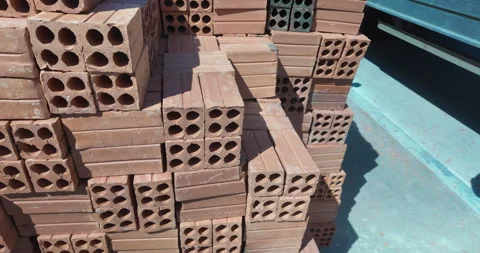 Close up of a worker stacking red bricks. Stock Footage 321850586