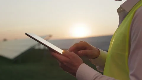 Close up of worker tapping on tablet screen among solar farm. Stock Footage 171854995