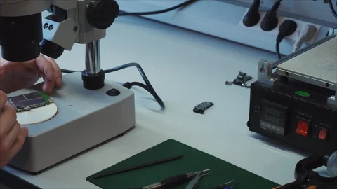 Close up , worker in testing lab. Specialist is testing a new mobile motherboard 스톡 동영상 105971427