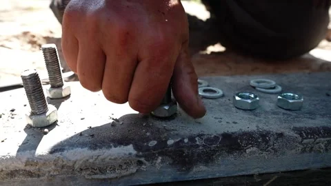 Close-up of a worker tightening nuts and bolts Stock Footage 258645643
