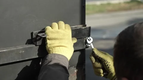 Close-up of a worker tightening nuts and bolts Video stock 261500427