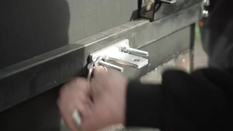 Close-up of a worker tightening nuts and bolts Video stock 261500441