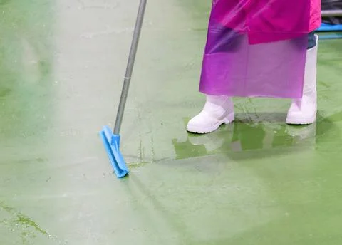 Close up worker use mob clean green floor. Stock Photos