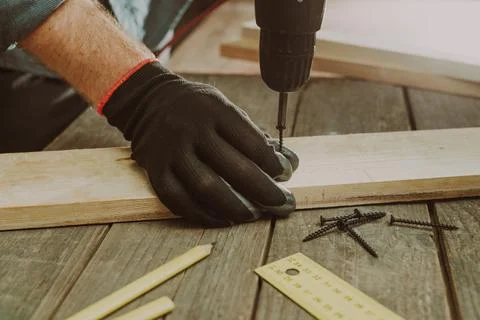 Close up of worker using electric scredriver on the table Stock Photos