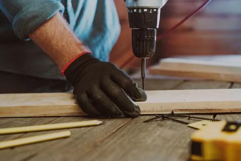 Close up of worker using electric scredriver on the table Stock Photos