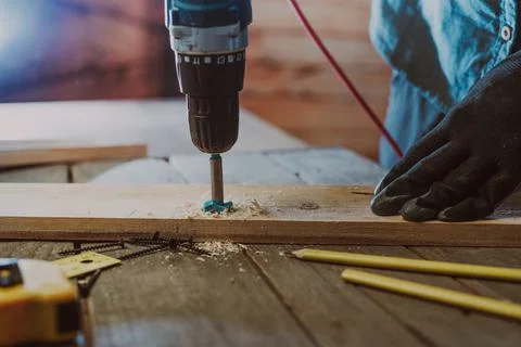 Close up of worker using electric scredriver on the table Stock Photos