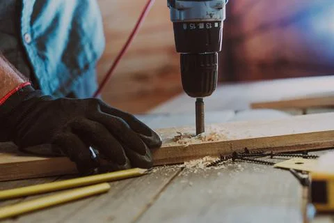 Close up of worker using electric scredriver on the table Stock Photos