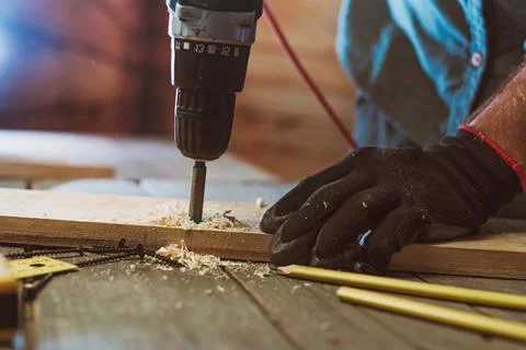 Close up of worker using electric scredriver on the table Stock Photos