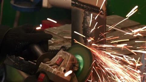 Close-up of a worker using an electric wheel grinding in a factory Video stock 314963157