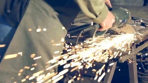 Close-up worker using industrial grinder on metal rail track parts in industrial 스톡 동영상 77143828