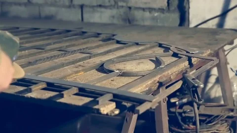 Close-up worker using industrial grinder on metal rail track parts in industrial Stock Footage 78205539