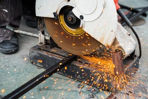 Close up worker using machine cutting steel Stock Photos