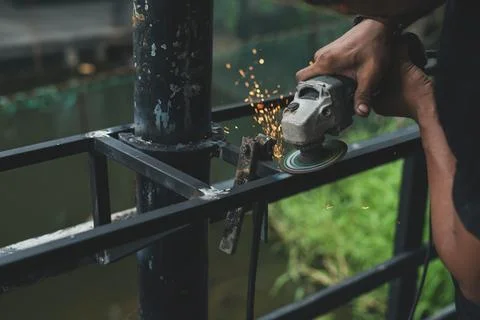 Close up worker using machine cutting steel Stock Photos
