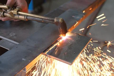 Close-up of a Worker Using an Oxy-Fuel Gas Cutting Torch on a Steel Plate Stock Photos