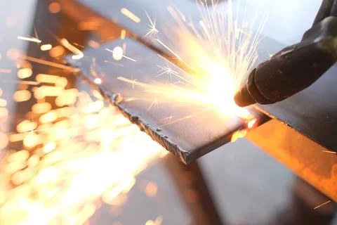 Close-up of a Worker Using an Oxy-Fuel Gas Cutting Torch on a Steel Plate Stock Photos