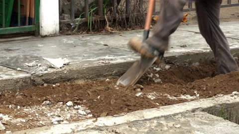 Close-up of a worker using a shovel with his hands and feet to remove debris of Video stock 160377508