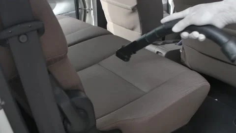 Close up of worker using vacuum cleaner in the car. Man vacuuming vehicle's Video stock 197555249