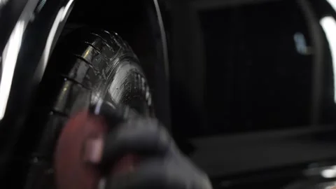 Close up. A worker waxes tires with a sponge. Tire wax. Video stock 247371777